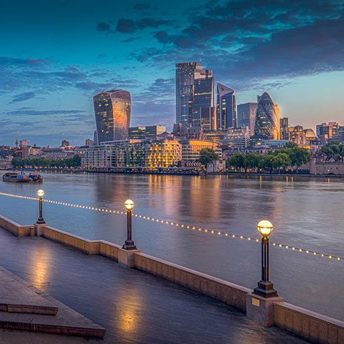 Financial district of London with the Thames in the foreground in the morning
