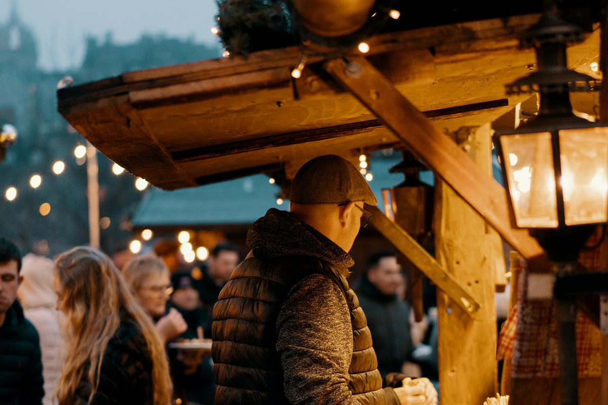 People visiting Christmas stalls at a Christmas Market