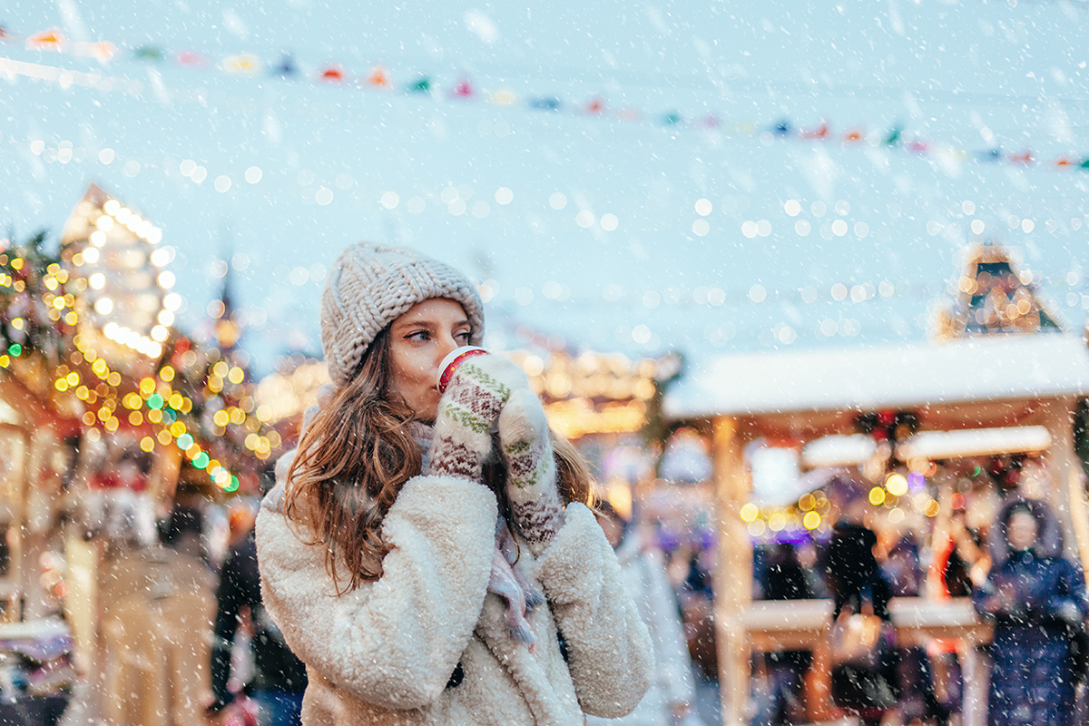 Female at Christmas Market drinking a hot drink