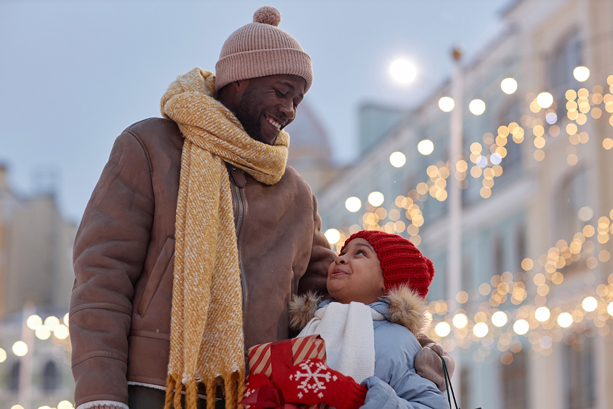 Parent and child walking down a street in winter