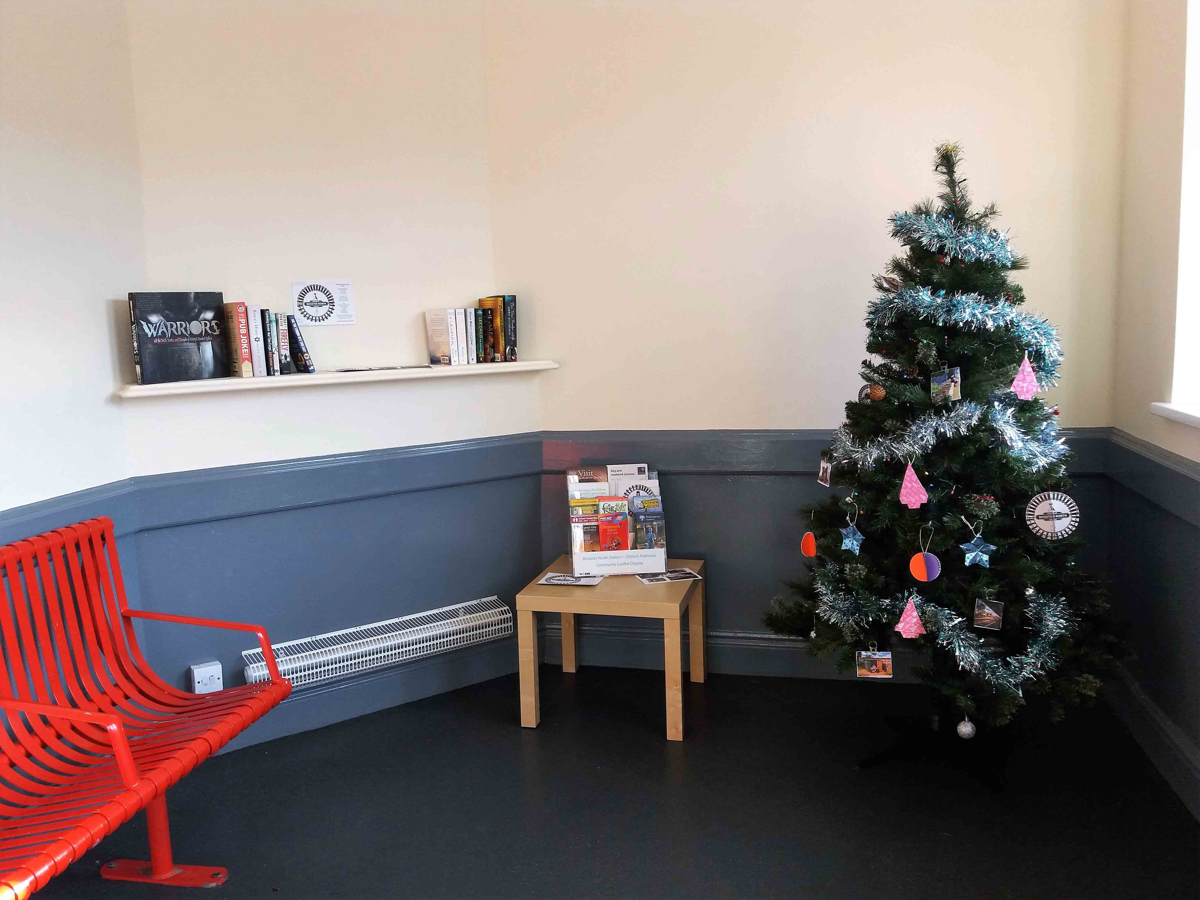 Community books and Christmas tree installed by the Friends of Bicester North station in the waiting room