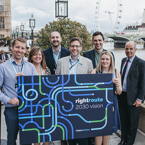 Members of the Chiltern railways team holding a Vision 2030 placard next to the river thames 