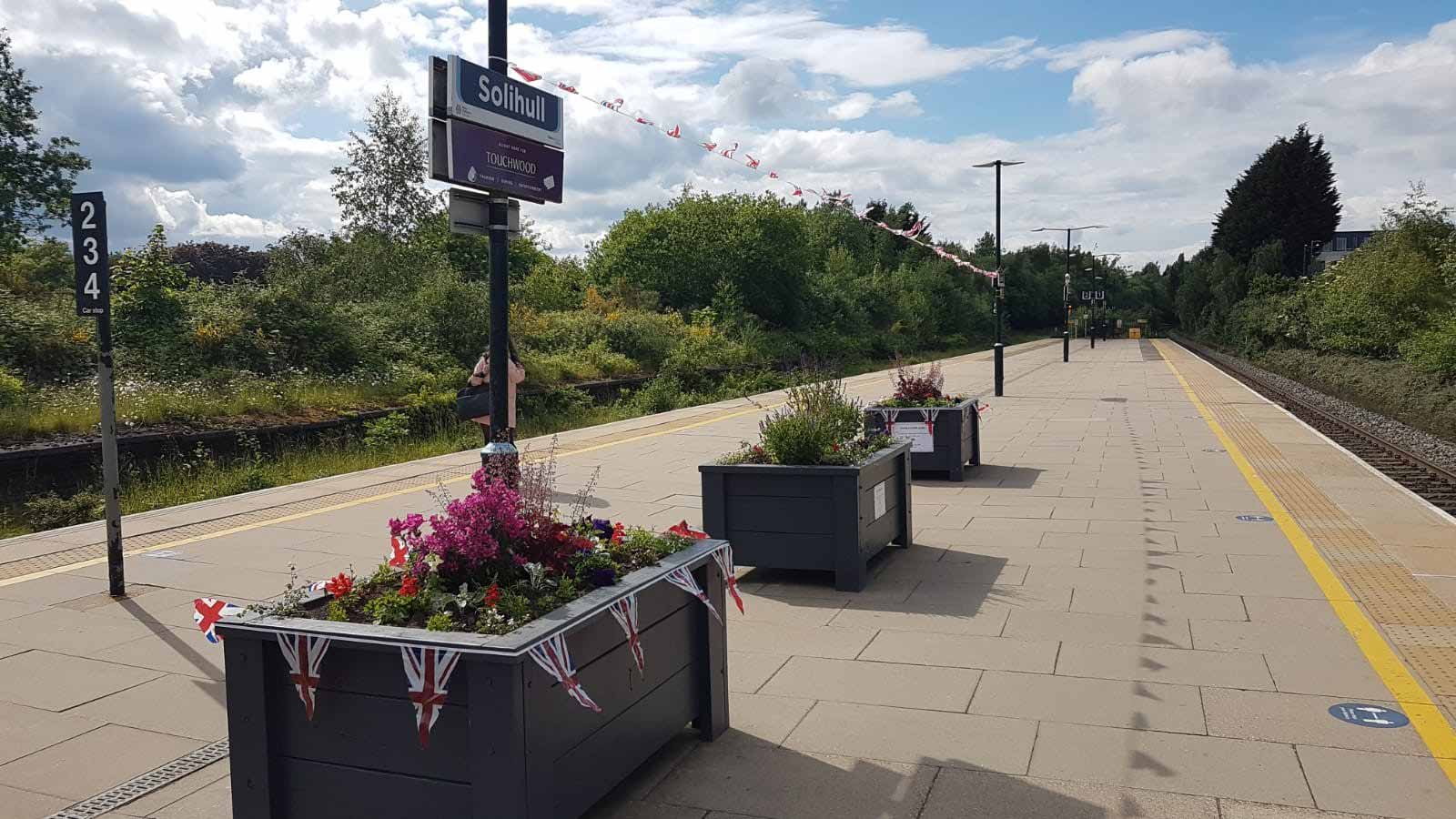 Solihull station with flower beds and Jubilee decoration