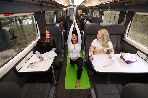 Passengers doing yoga on the train