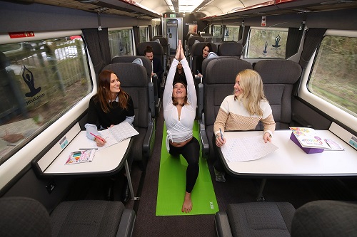 Passengers do a yoga class on a train