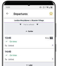 Phone showing live train times with icon indicating 90%+ seat capacity occupied on trains