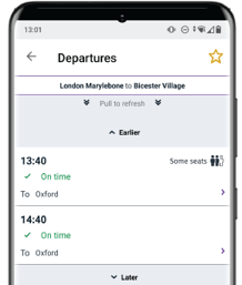 Phone showing live train times with icon indicating between 60-89% seat capacity on trains