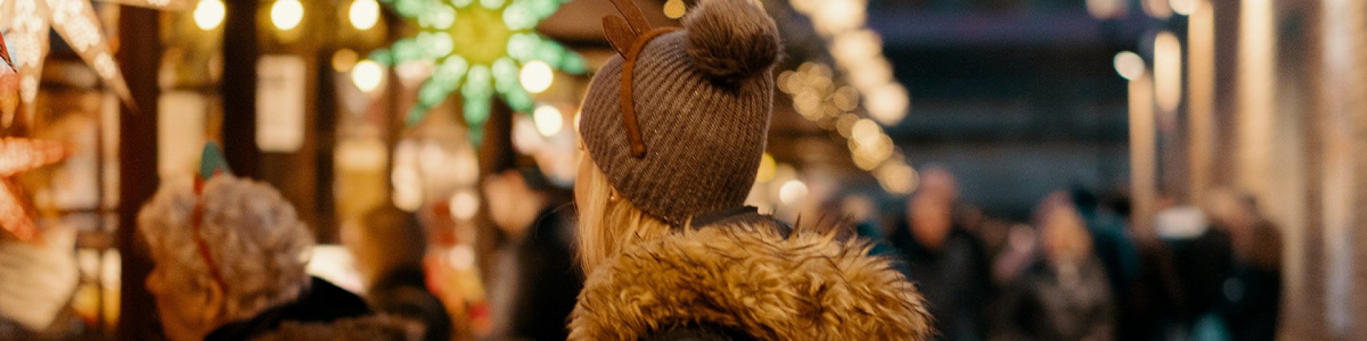 People visiting Christmas stalls at a Christmas Market