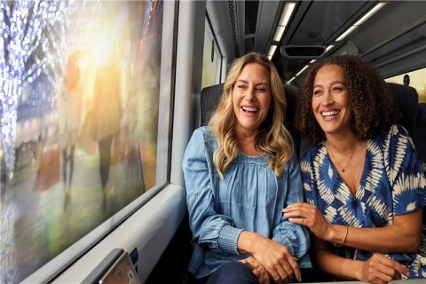 2 women on train daydreaming about shopping